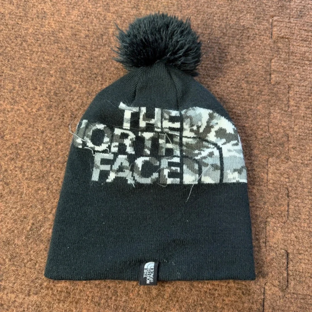 B- The North Face Youth Beanie Black Camo Logo Pom Pom Knit Hat Small S/P